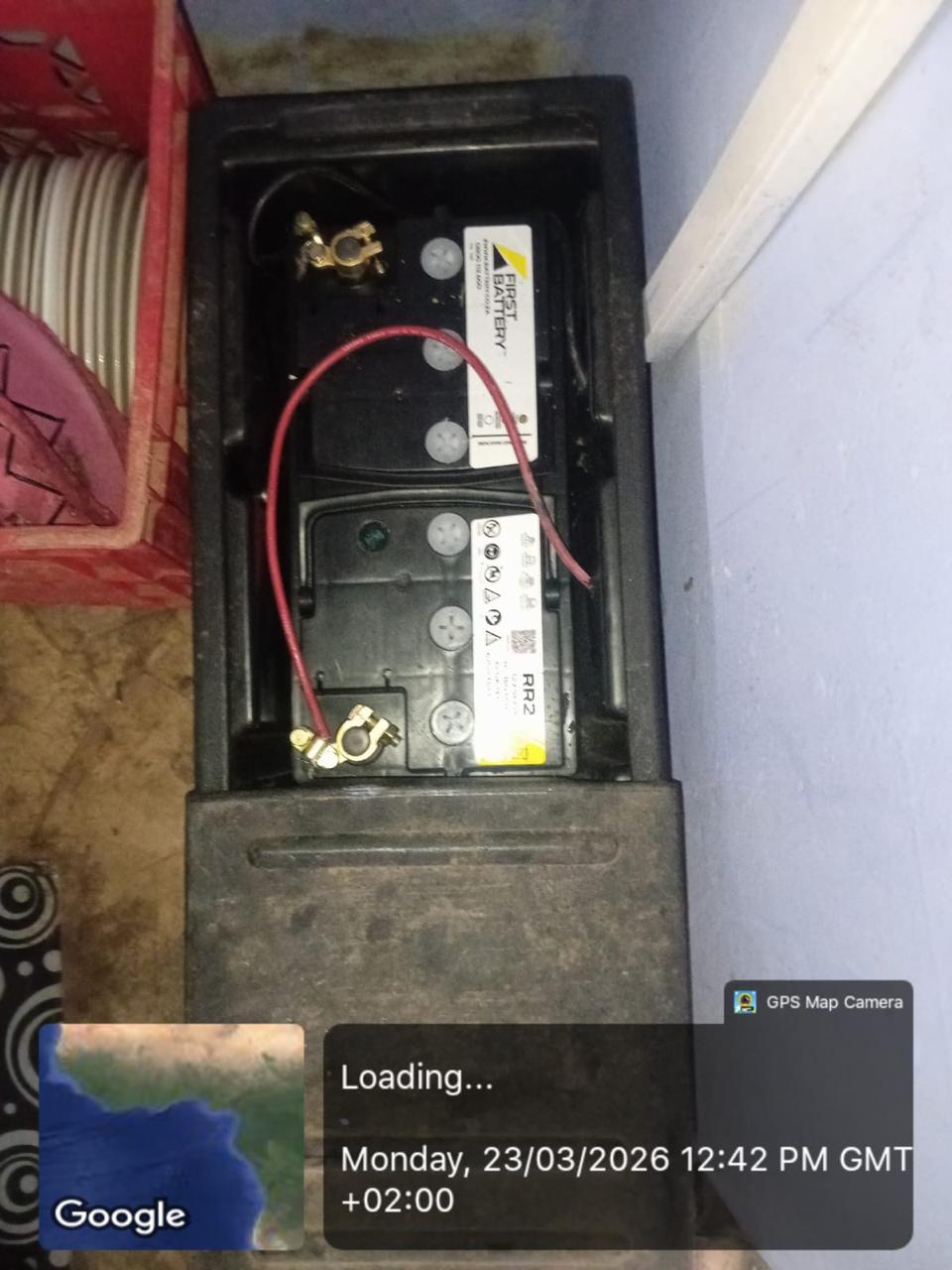 Battery unit installed inside a black enclosure with connected terminals.