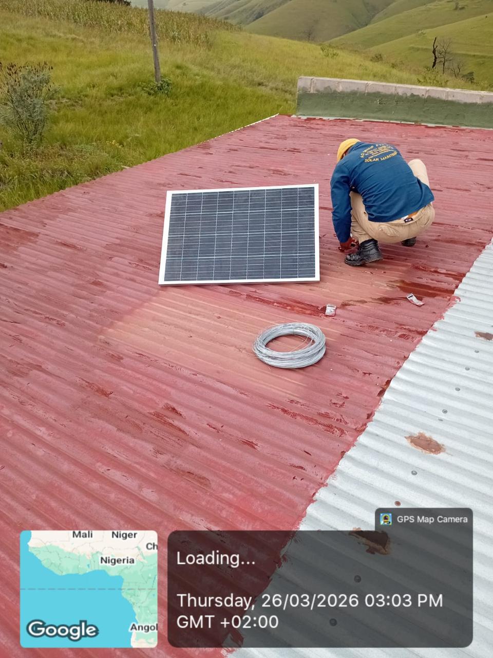 Technician working beside a solar panel during installation.