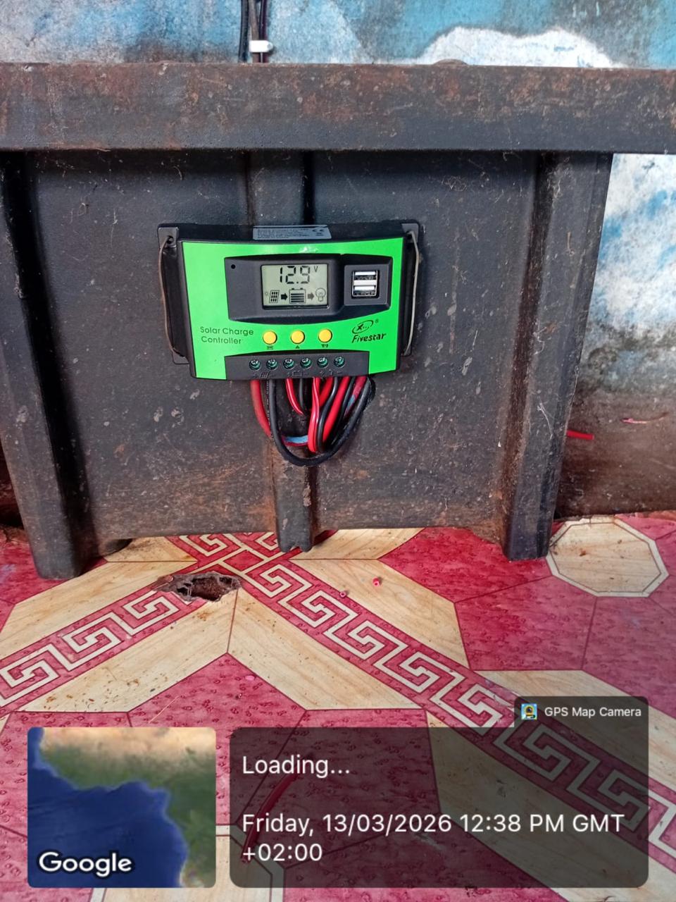 Green solar charge controller installed inside a cabinet.