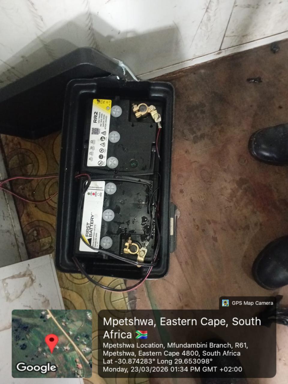 Battery storage unit with connected cabling inside a housing.