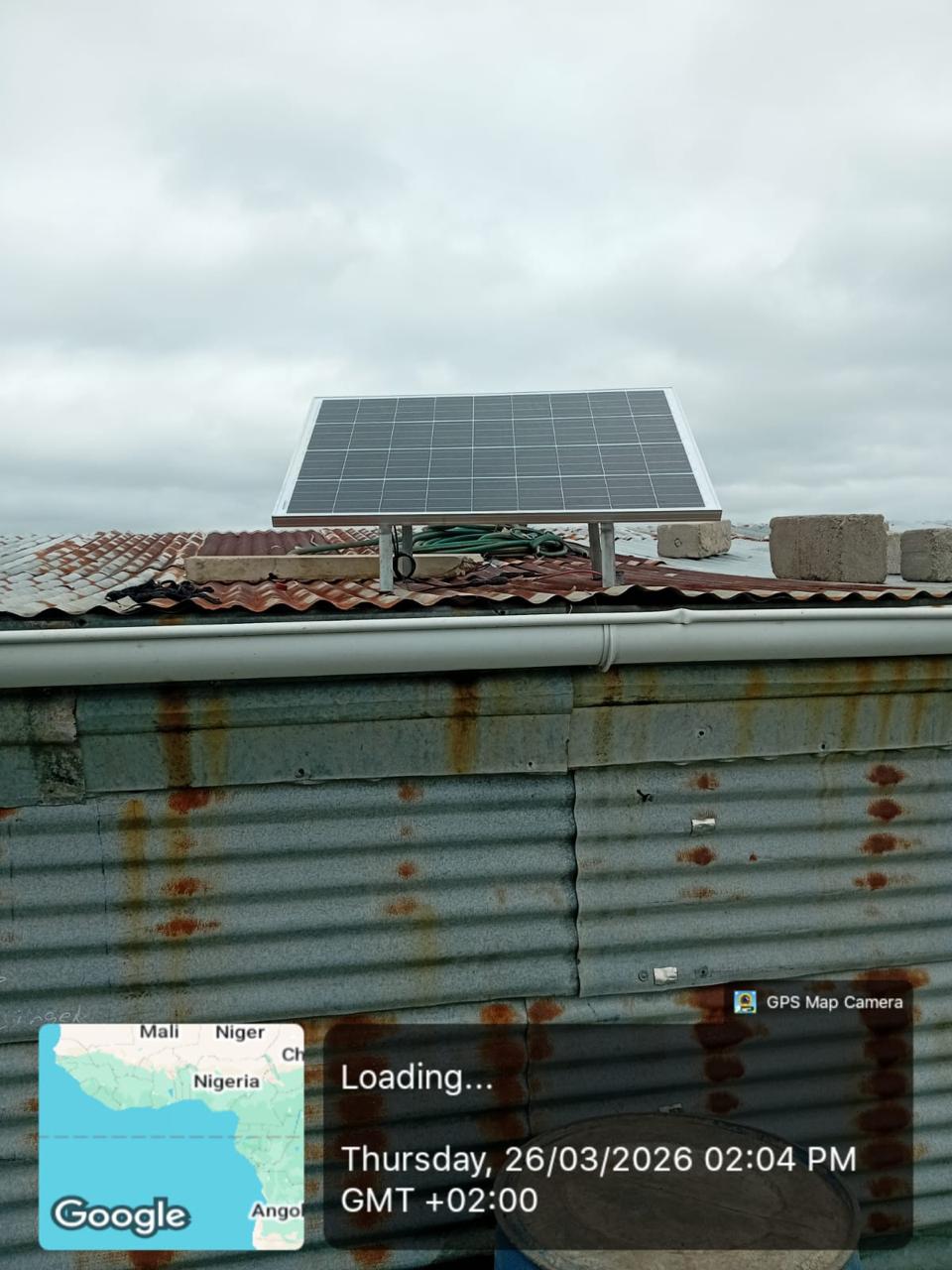 Mounted solar panel displayed above a corrugated roof facade.